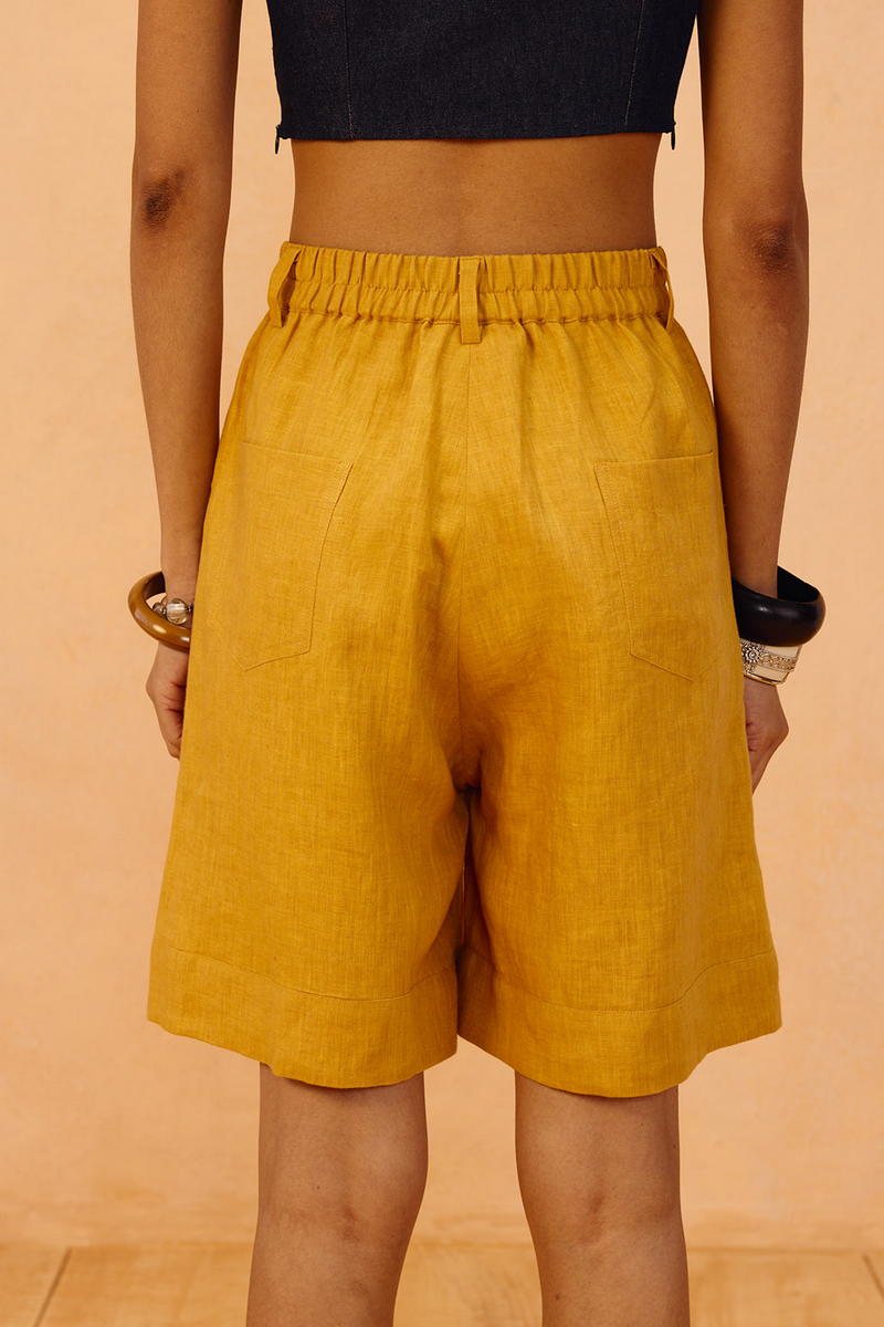 The Golden Linen Shorts 100% linen short by SUI in mustard for women in Singapore